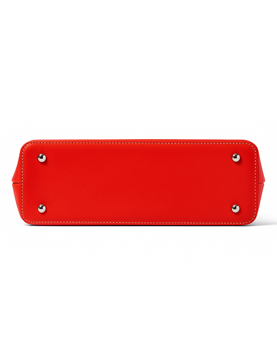 Red handbag with silver studs on bottom on a white background