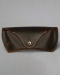 Brown leather case with a button on a white background