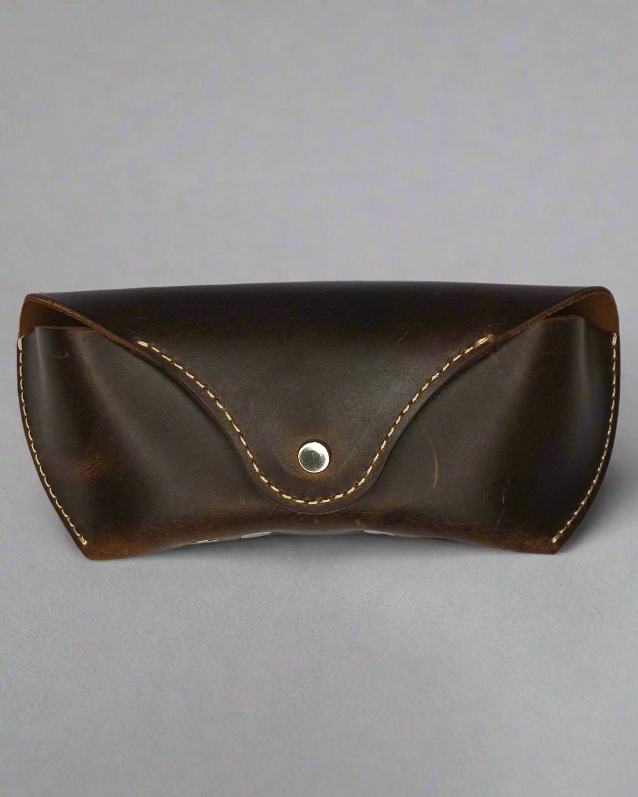 Brown leather case with a button on a white background