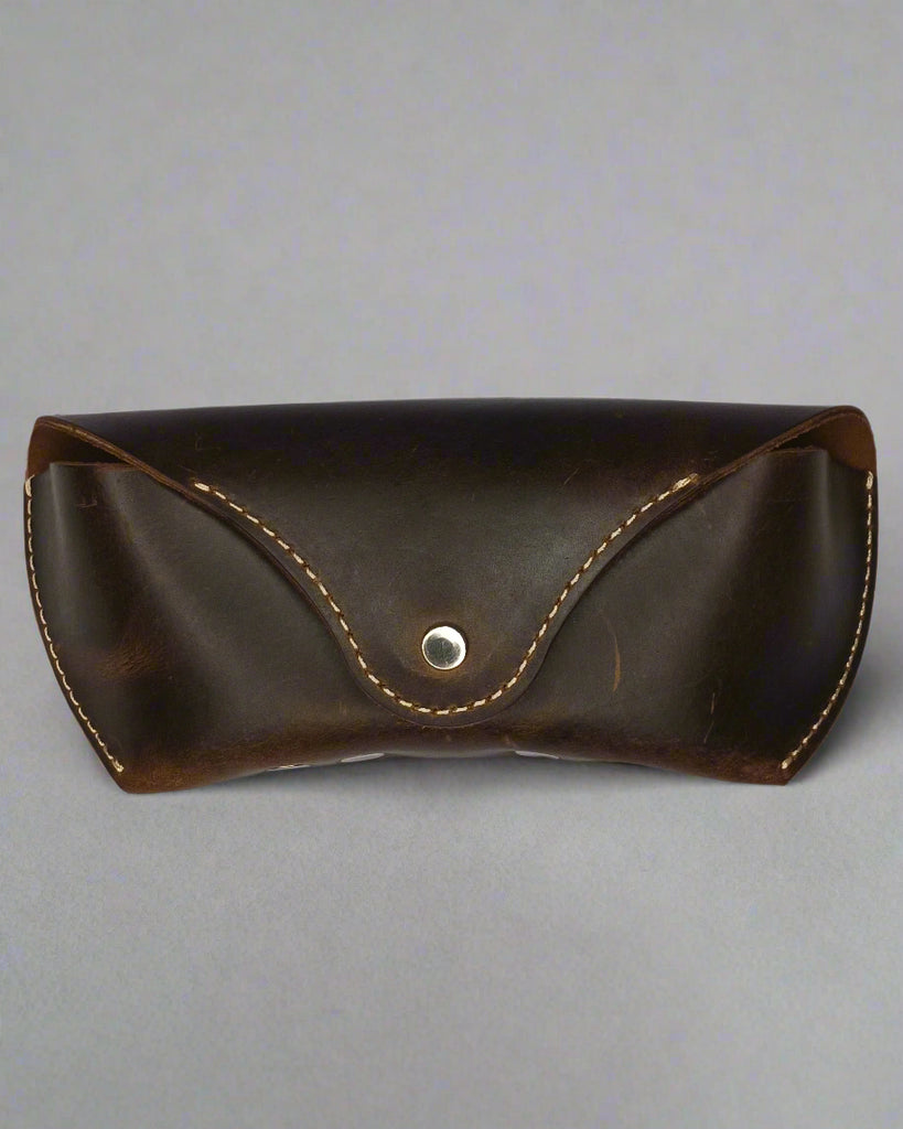 Brown leather case with a button on a white background