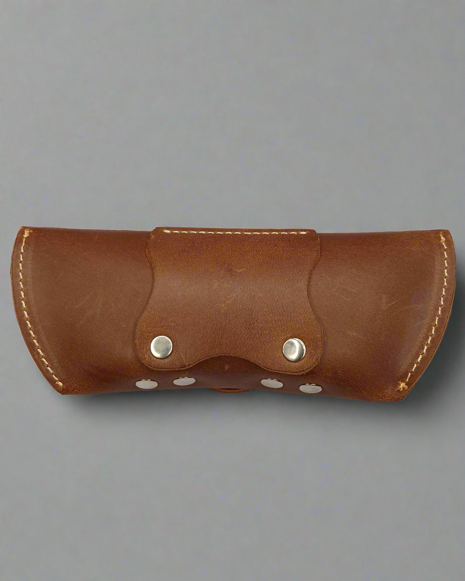 Brown leather case with silver buttons on a white background