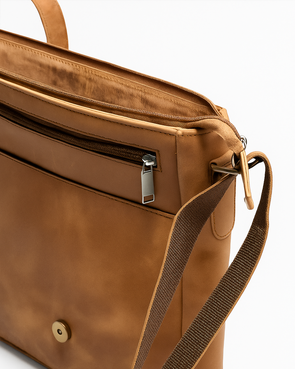 Brown leather bag with a strap on a white background