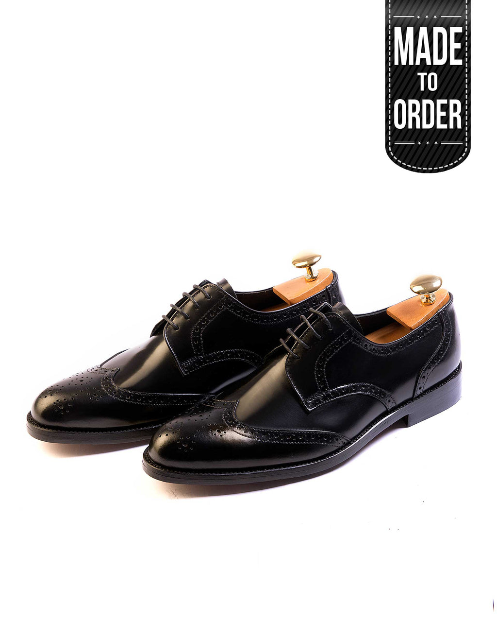 A pair of black Salemanco Brogue shoes with a lace-up closure. The shoes feature a polished leather upper with intricate perforations and a visible anti-bacterial inner lining.