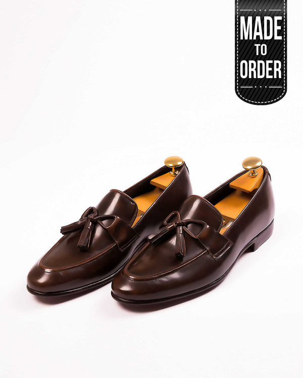 A pair of brown leather tassel shoes on a white background with a 'Made to Order' label.