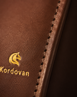Close-up of the Dave Brown nappa leather grain and stitching on The Elite mobile wallet