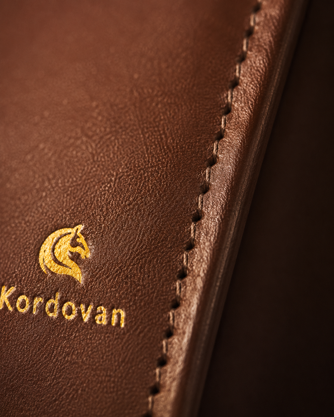 Close-up of the Dave Brown nappa leather grain and stitching on The Elite mobile wallet