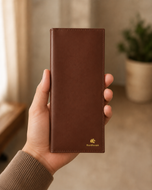 The Elite Dave Brown leather mobile wallet held in hand, showing its slim full-length profile