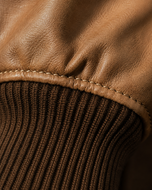 Desert Voyager — men's brown sheepskin leather bomber jacket, close-up of the leather grain and hardware | Kordovan Pakistan