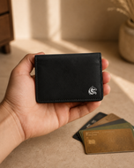 Black leather Elite Card Holder held in hand, showing its slim shirt-pocket size