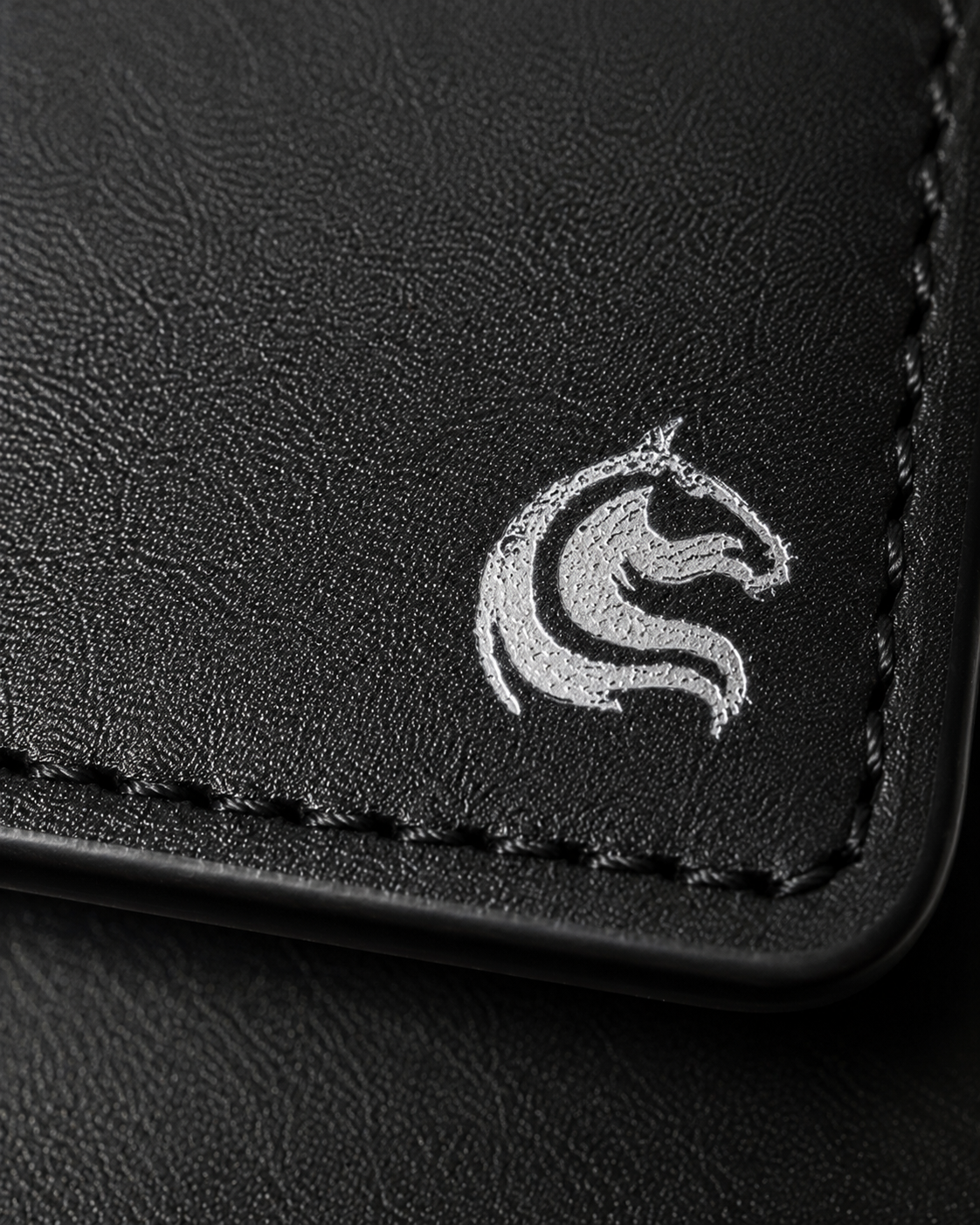 Close-up of the burnished black cow leather grain on the Elite Card Holder