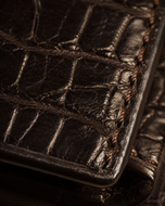 Close-up of the crocodile-embossed brown cow leather texture on the Gator wallet