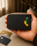 Black HM The Lord's leather wallet held in hand for scale