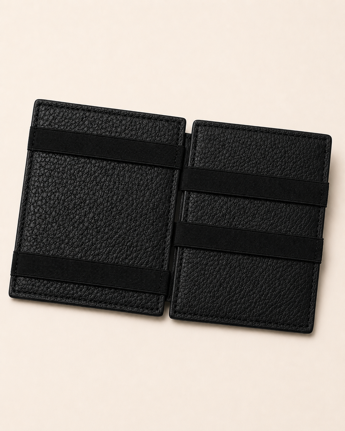 Black ILLUSION magic wallet open — crossed elastic holding notes, cards in their slots