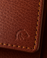 Close-up of the light brown pebble-grain leather texture on the Kingsman wallet