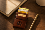 Brown Kodo Vertical 2.0 RFID leather wallet styled on a desk — Kordovan smart wallet