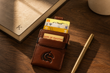 Brown Kodo Vertical 2.0 RFID leather wallet styled on a desk — Kordovan smart wallet
