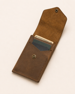 The Luke wallet open — vertical card stack and centre bill slot in full-grain leather