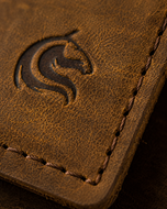 Close-up of the full-grain cow leather grain and hand-stitching on The Luke wallet