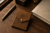 The Luke vertical leather wallet on a walnut desk — minimalist everyday carry by Kordovan