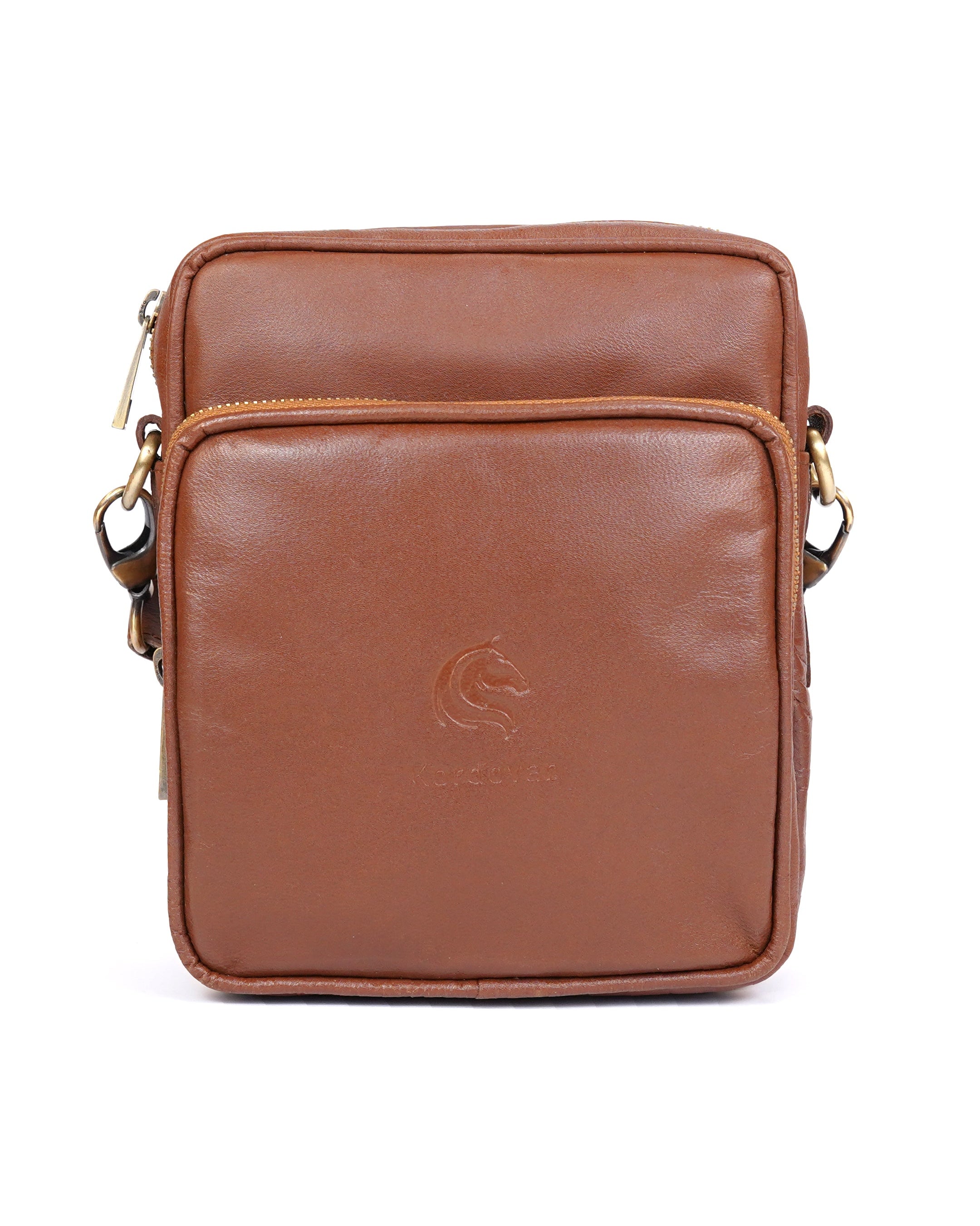 A brown leather messenger bag with a front zippered pocket and brass hardware, viewed from the front.