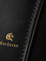 Close-up of the Midnight Black nappa leather texture on The Elite mobile wallet