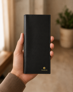 The Elite Midnight Black leather mobile wallet held in hand for scale