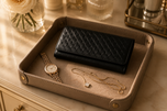 Black Nova woven clutch styled on a marble surface — Kordovan