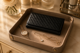 Black Nova woven clutch styled on a marble surface — Kordovan