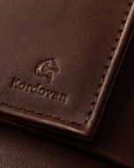 Close-up of the soft tan nappa leather grain and topstitching on the Kordovan bifold