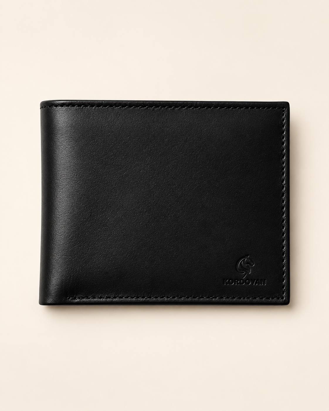 Plain bifold nappa leather wallet in black — front view with embossed Kordovan mark | Pakistan