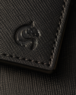 Close-up of the black saffiano cross-hatch texture and angular edge detail