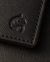 Close-up of the black saffiano cross-hatch texture and angular edge detail
