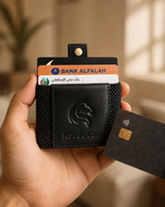 Black KODO RFID smart wallet held in hand, showing extremely slim profile