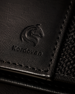 Close-up of the full-grain Crazy Horse leather and elastic on the black KODO wallet