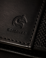Close-up of the full-grain Crazy Horse leather and elastic on the black KODO wallet