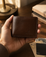 Brown Rigor Lite sheep leather slim wallet held in hand, showing flat profile