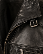 Rockafella — men's black sheepskin leather jacket, close-up of the leather grain and hardware | Kordovan Pakistan