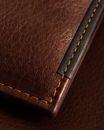 Close-up of the soft milled cow leather grain and topstitching on the Shelby wallet