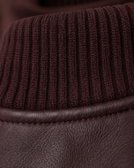 Sinclair — women's maroon leather bomber jacket, close-up of the leather grain and ribbed trim | Kordovan Pakistan