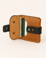 The Hunter HM wallet open — card slots and hidden cash pocket in genuine cow leather