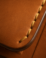 Close-up of the strap closure and antique brass stud on the Hunter HM wallet