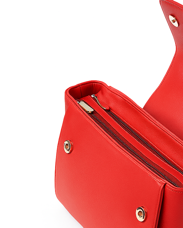 Red handbag with a gold zipper on a white background