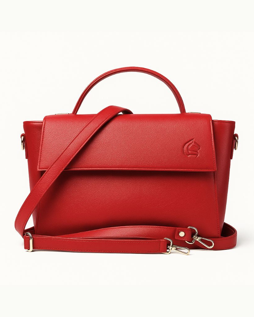 Red handbag with a strap on a white background
