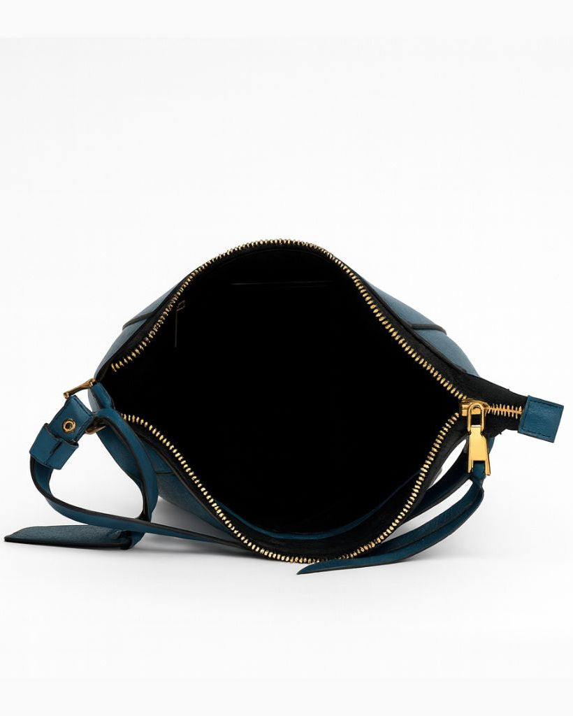 Blue leather bag with gold zipper on a white background