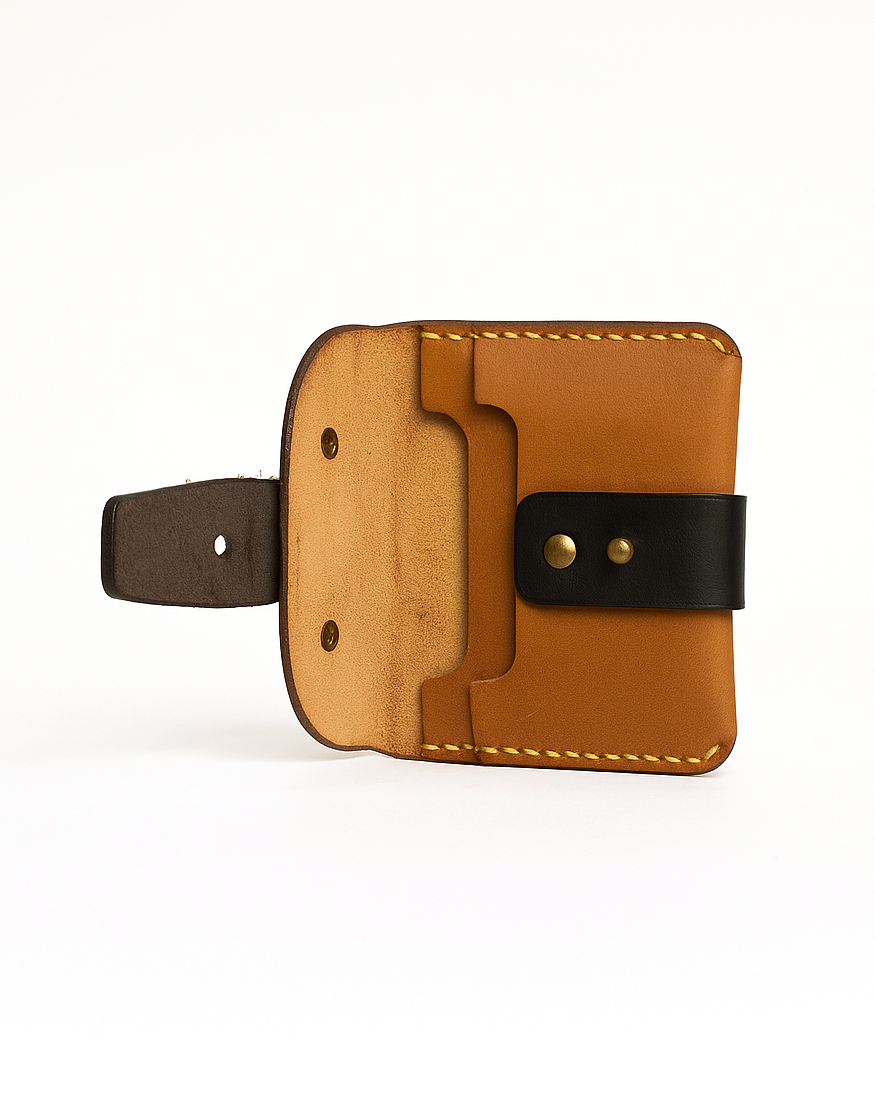 Brown handcrafted leather wallet with black strap on a white background