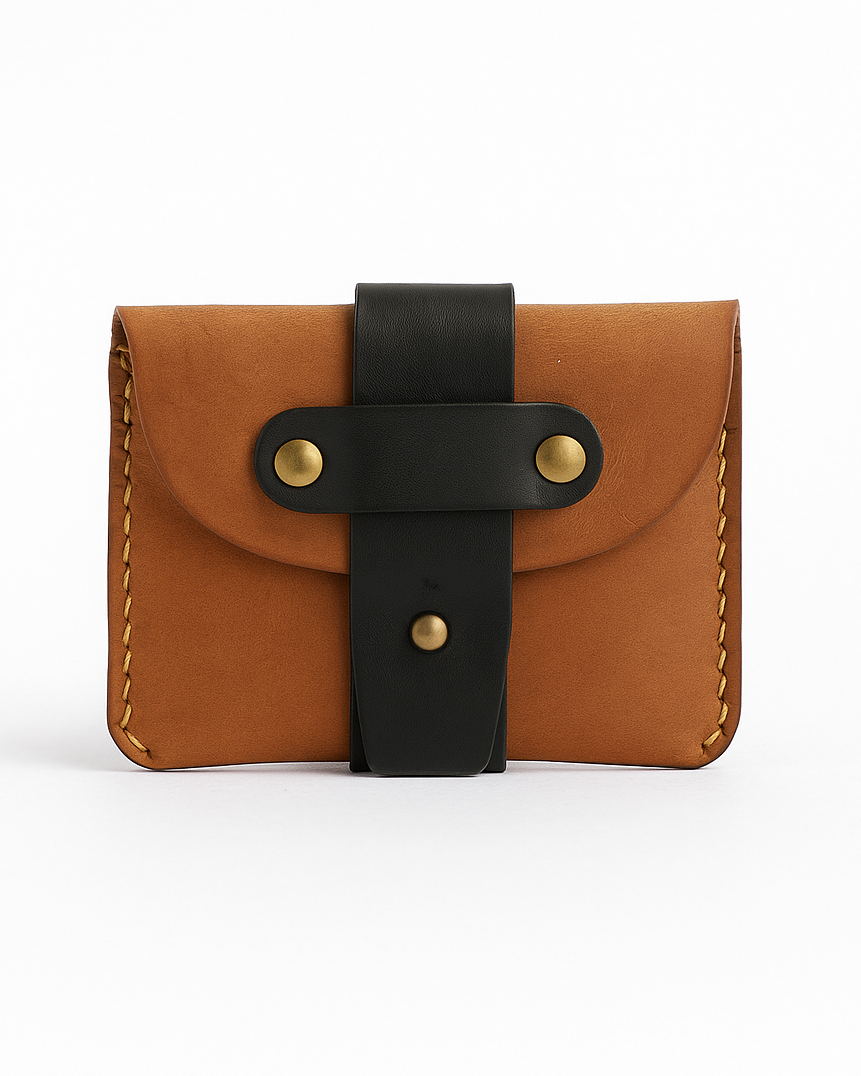 Brown handmade leather wallet with black strap on a white background