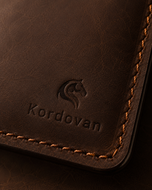 Close-up of the dark brown Crazy Horse leather texture on the Kordovan long wallet