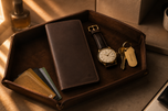 Dark brown Crazy Horse long wallet styled on a walnut desk — Kordovan leather goods