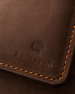 Close-up of the waxed, scuffed Crazy Horse leather grain on the light brown long wallet