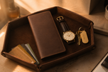 Light brown Crazy Horse long wallet resting on a café table — Kordovan leather everyday carry